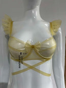 Latex bra with underwire, bow detail, and ruffled straps.